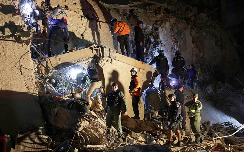 Emergency services work at the site of a collapsed building in Caracas, Venezuela, June 24, 2026.