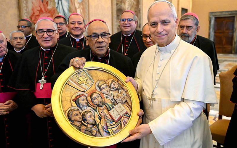 Pope Leo XIV, seen with Peruvian bishops Jan. 30, 2026, holds an image they presented to him that shows Jesus Christ at the center, with St. Rose of Lima, upper left, and other Church figures.