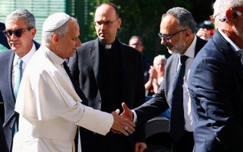 Pope Leo XIV is greeted by his personal physician, Luigi Carbone, as the pontiff arrives at Rome's Gemelli Hospital Oct. 13, 2026, ahead of his surgery that afternoon to remove a lung nodule.