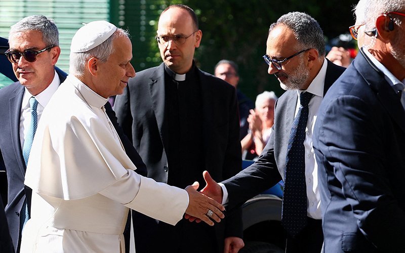 Pope Leo XIV is greeted by his personal physician, Luigi Carbone, as the pontiff arrives at Rome's Gemelli Hospital Oct. 13, 2026, ahead of his surgery that afternoon to remove a lung nodule.