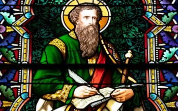 Stained-glass depiction of St. Paul holding a scroll and sword